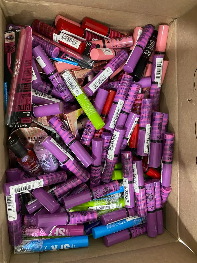 Large pile of assorted NYX and Maybelline lip cosmetics from a liquidation load